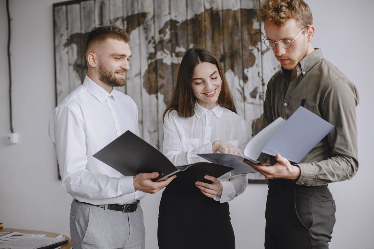 Coworkers looking at documents together during a review