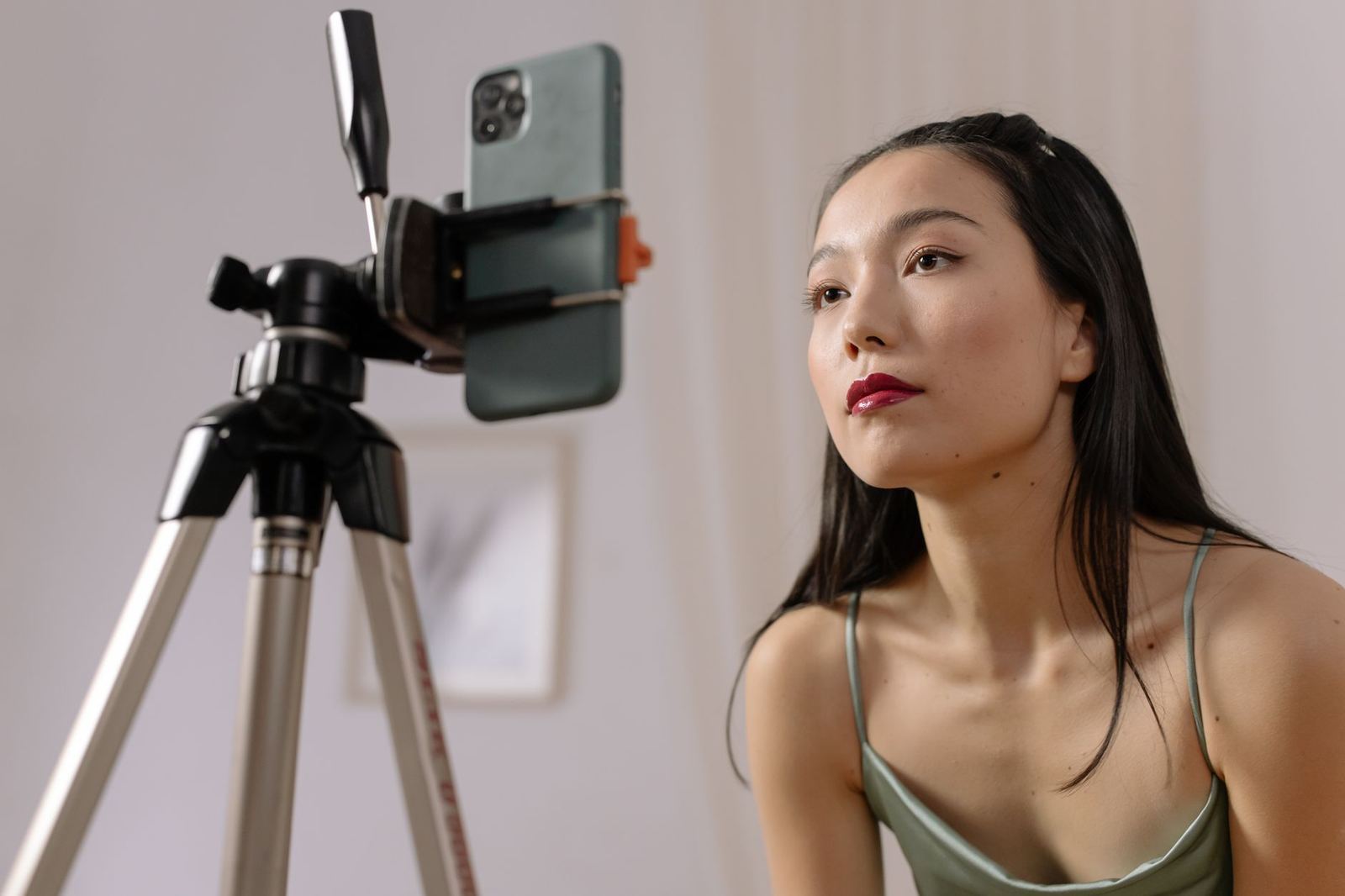 A creator filming content on a smartphone with a tripod setup