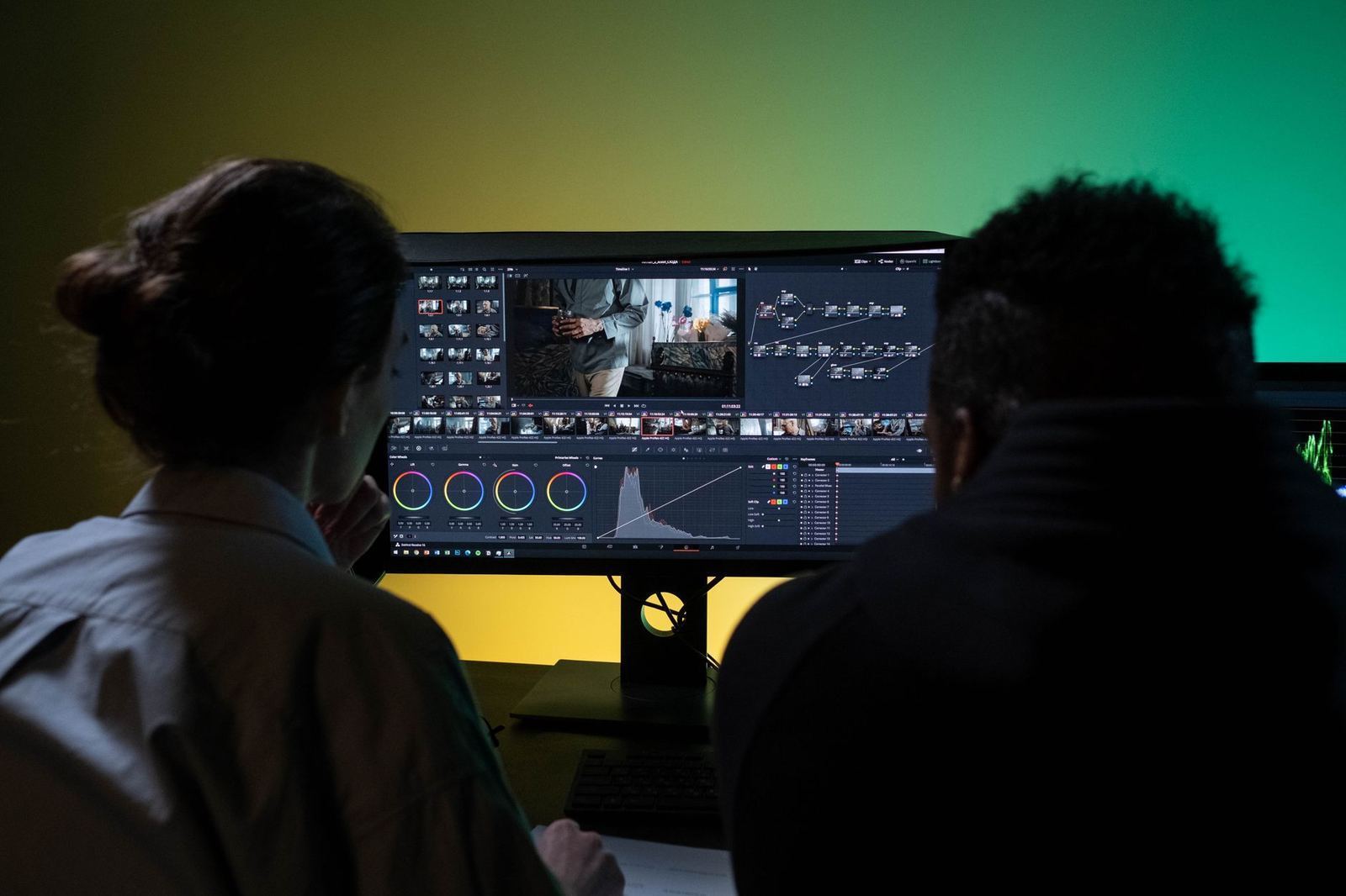 Two people reviewing video footage together on a computer monitor