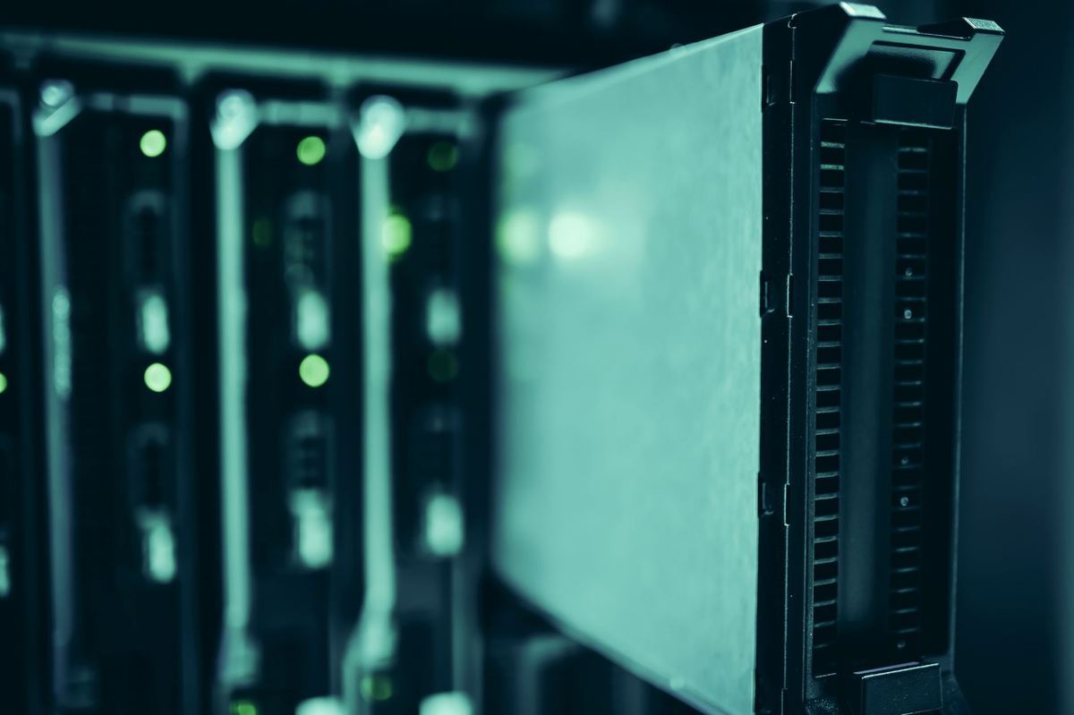 A close-up of server hardware being slid into a rack in a data center