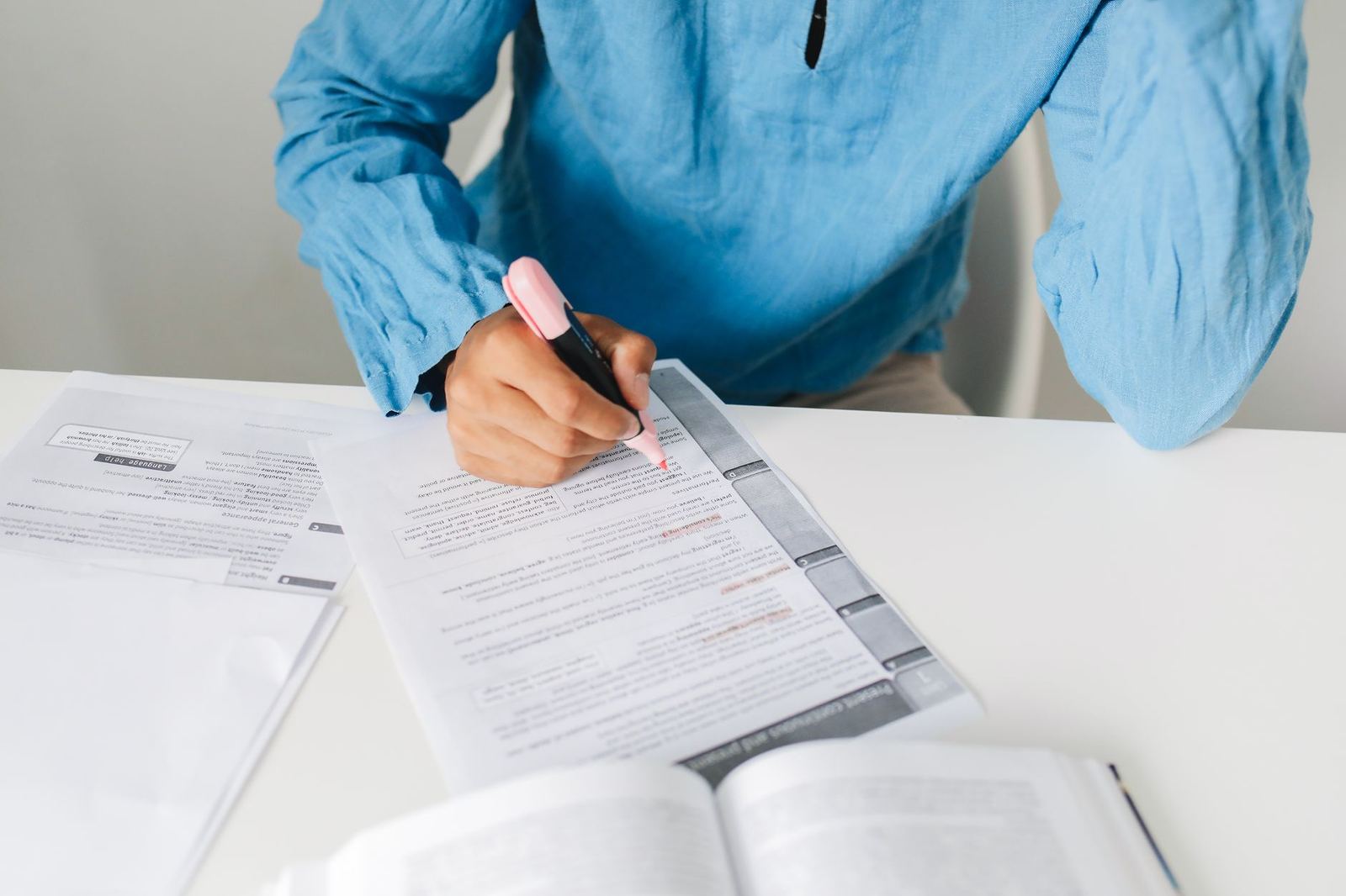 A person marking up document annotations on a laptop