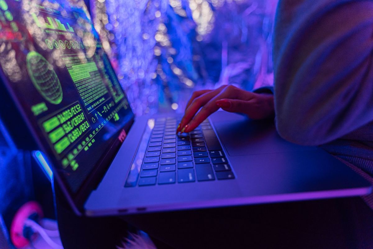 A person typing on a laptop keyboard