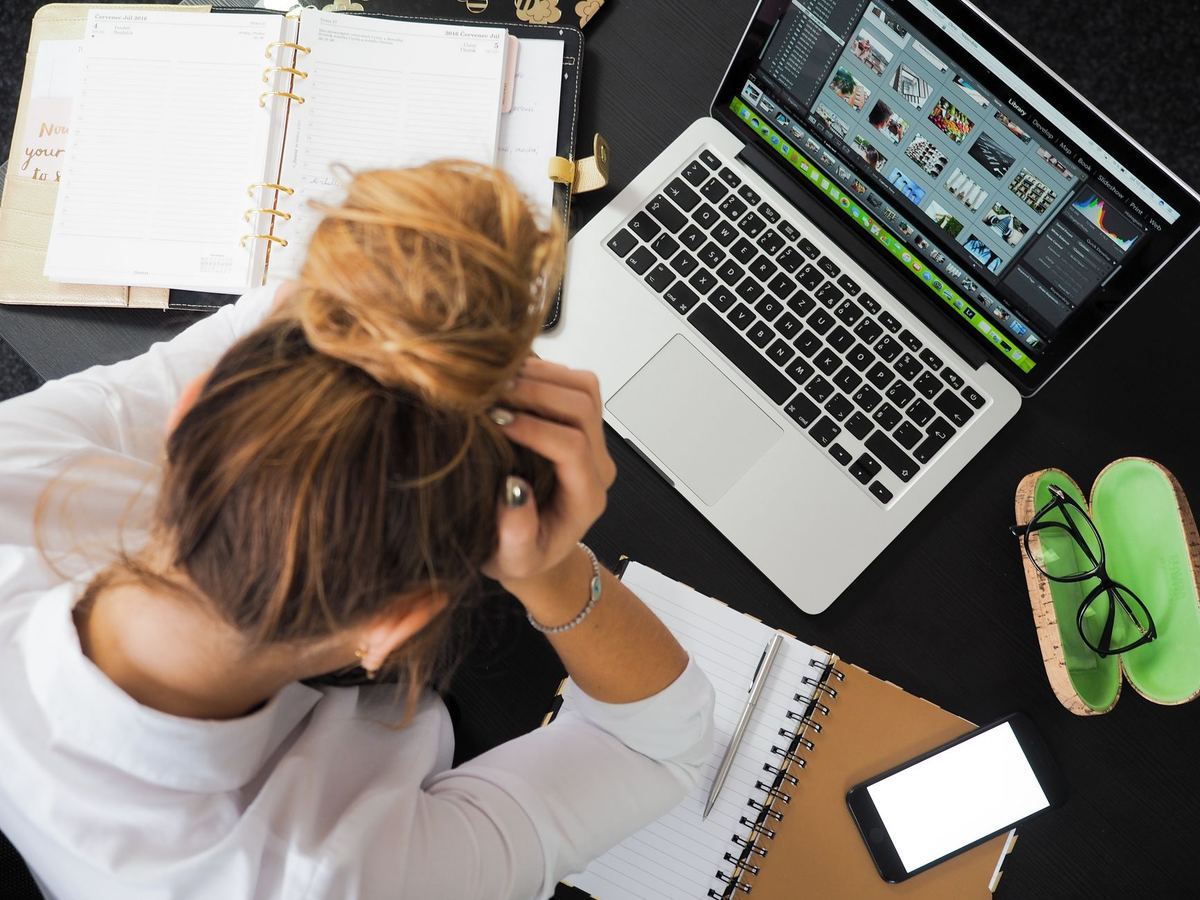 A person looking frustrated at a laptop screen
