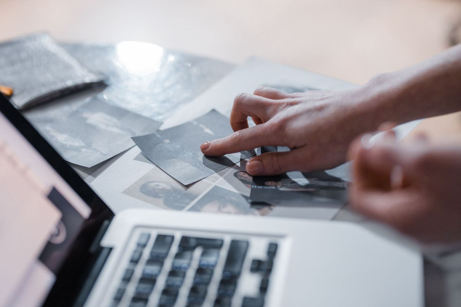 A photographer sending large files to a client from a laptop